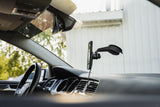 Quad Lock V6 Window and Dash Car Mount with adjustable 360° gimbal head, showcasing the versatile device attached to a vehicle interior.