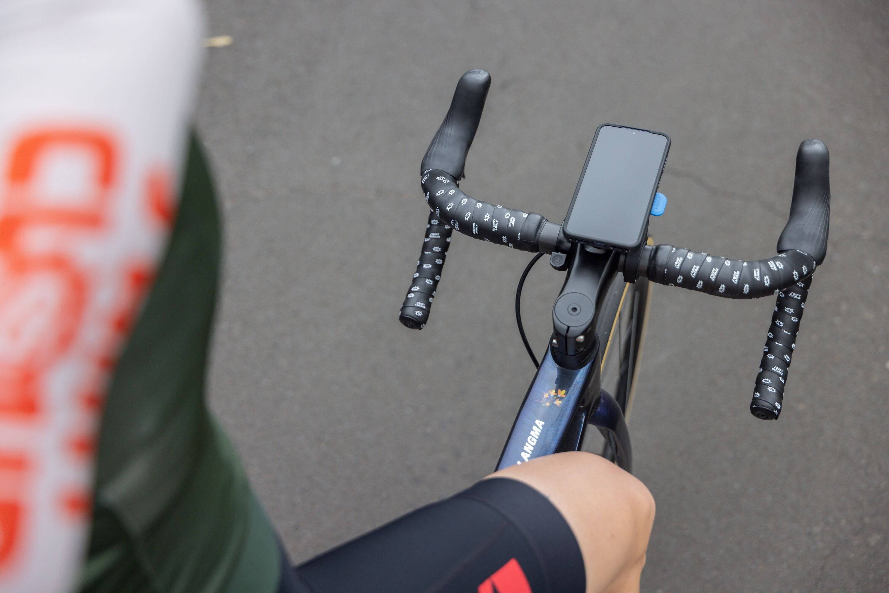 Quad Lock Out Front Mount V3 for smartphones, showing sleek modular accessory-compatible mounting system on a car dashboard.