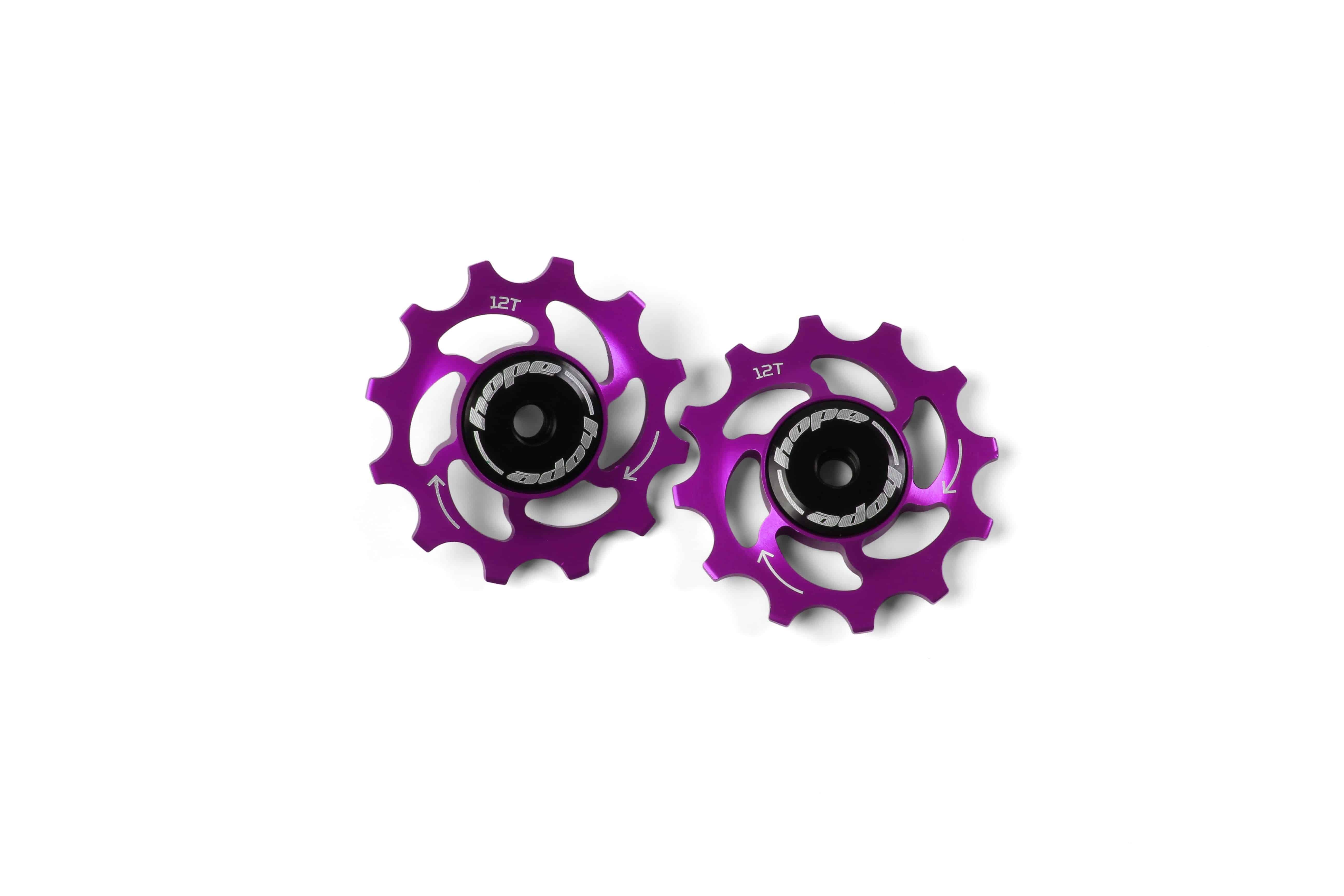 Pair of Hope 12-tooth jockey wheels for bike drivetrain, showing smooth, durable components designed for efficient cycling performance.