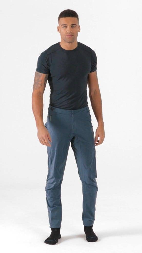 Rab Cinder Kinetic waterproof outdoor pants for men with an adjustable waistband, designed for durability and active outdoor wear.
