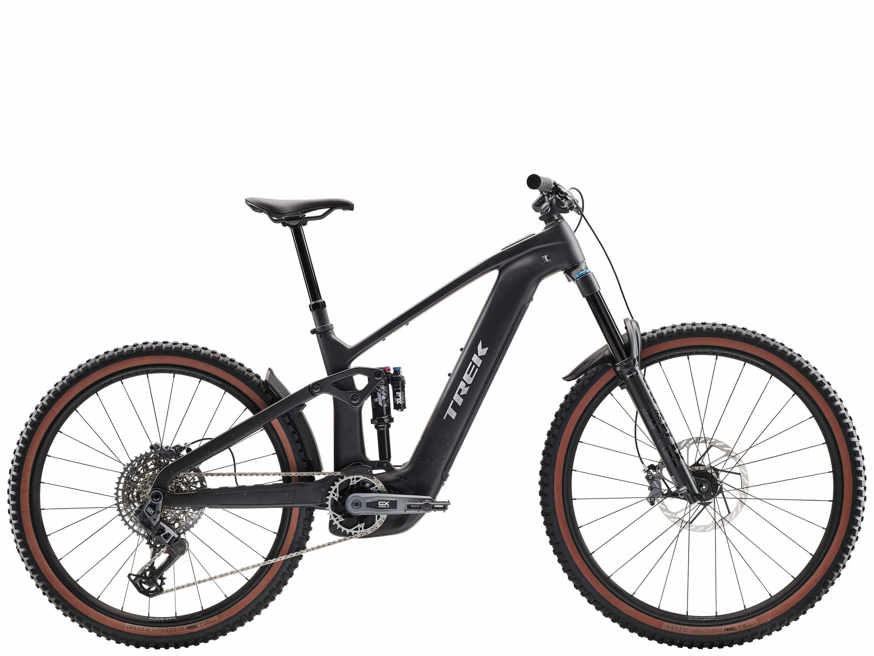 Trek Rail+ 9.8 GX AXS 2025 electric mountain bike with 29-inch wheels and Gen 5 motor, shown on rugged trail.