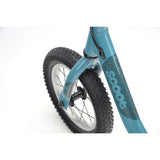 Ridgeback Scoot 2027 kids balance bike in teal for toddlers age 2+, close-up of frame and handlebars.