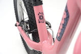 Pink Ridgeback Scoot XL kids balance bike with 14-inch wheels, designed for beginner riders aged 3 and up.