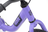 Ridgeback Scoot XL 14-inch kids' balance bike in lilac with black grips, designed for beginner riders aged 3 and up.