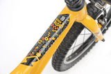 Yellow Ridgeback MX16 kids bike with 16-inch wheels, adjustable for ages 3½ to 6 years, featuring a sturdy frame and training wheels.