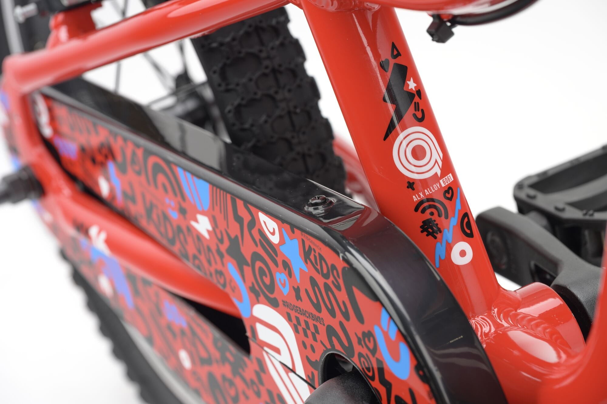 Red Ridgeback MX16 kids bike with 16-inch wheels, adjustable frame for ages 3.5 to 6, detailed close-up of the bike frame.