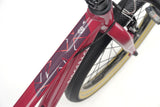 Ridgeback Dimension 20 Kids Bike for ages 5+ with 7-speed Shimano gears, featuring a plum frame and detailed design.