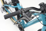 Teal Ridgeback Dimension 24 Kids Bike with 8-speed Shimano gears and puncture-resistant tires, adjustable for ages 8 and up.