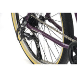 Ridgeback Dimension 24 kids bike in violet featuring 8-speed Shimano gears, puncture-resistant tires, and adjustable fit for ages 8+