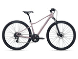 Liv Rove 4 women’s hybrid bike with suspension fork and disc brakes, shown with sleek frame and ergonomic handlebars.