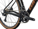 Giant Revolt Advanced 2 MY26 gravel bike with adjustable wheelbase and shock absorption, featuring a sleek frame and knobby tires.