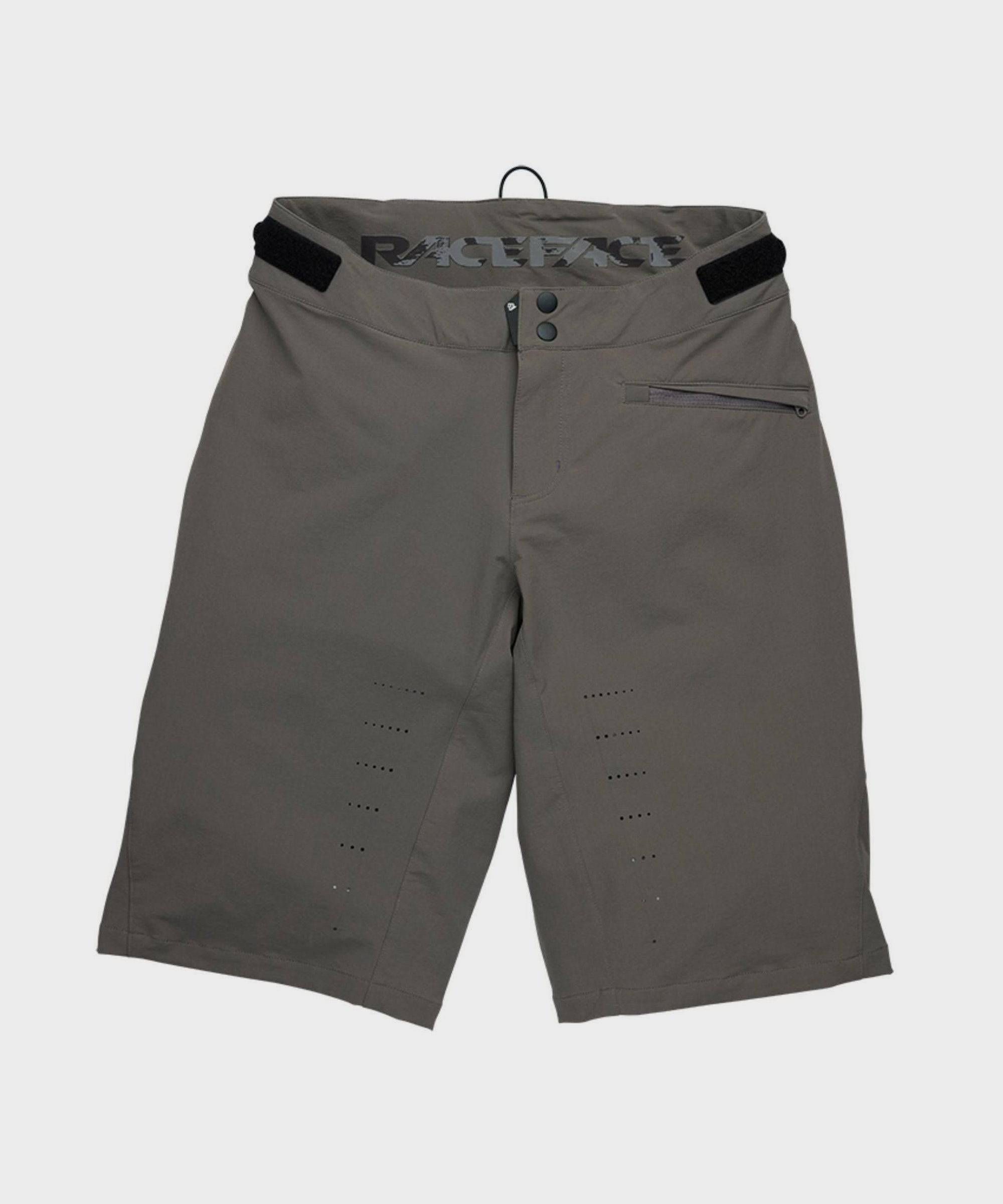 Race Face Indy Women's Mountain Bike Shorts showing adjustable waist, zippered pockets, and durable outdoor clothing design.
