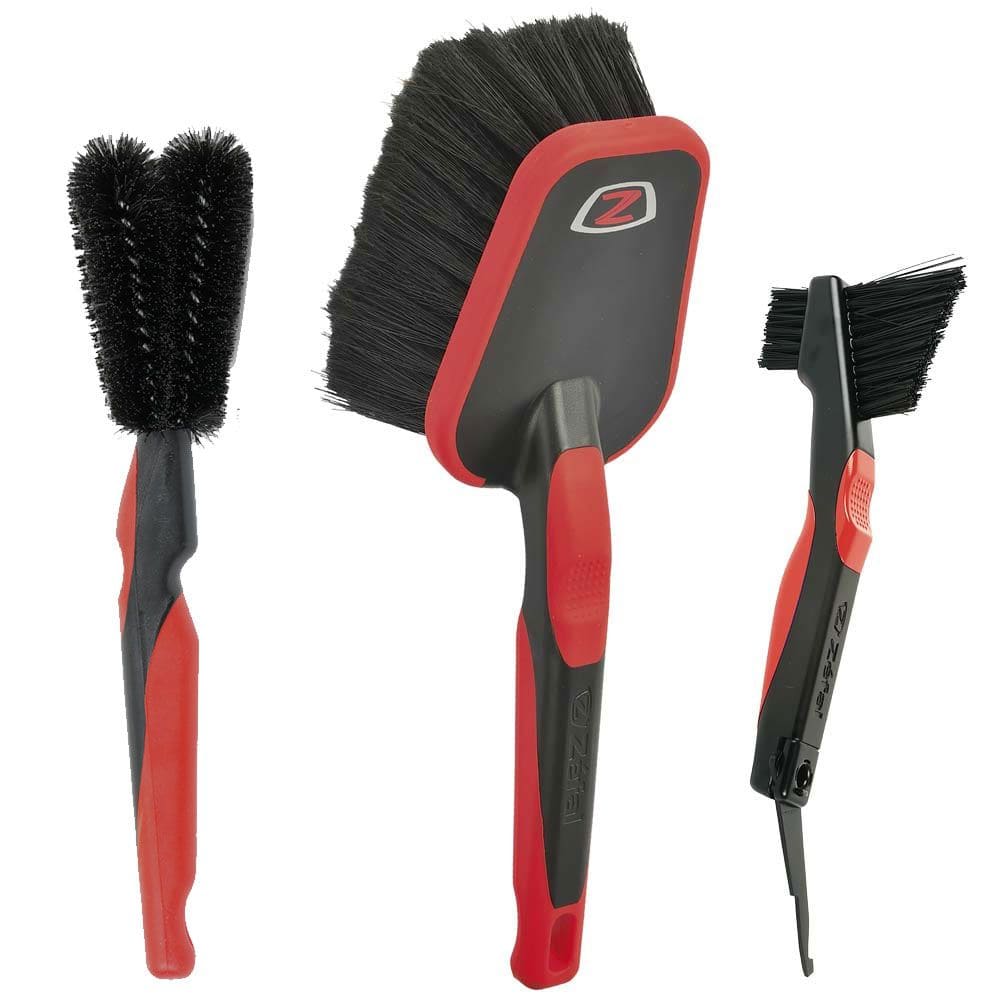 Zefal ZB Brush Set for bike cleaning, including brushes for wheels, chains, and frames, displayed on a workshop surface.