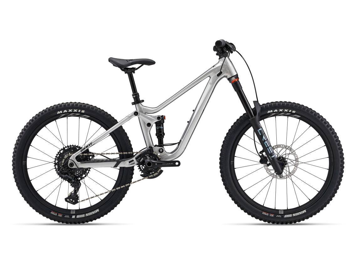 Giant Faith 24 youth mountain bike with suspension and dropper seatpost, showing sturdy frame and off-road tires.
