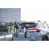 Thule OutWay rear-mount 2 bike carrier rack with anti-sway mechanism and locking cable attached to a vehicle for bike transportation.