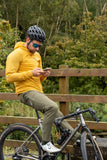 Madison Roam men's lightweight windproof packable jacket hanging on a hanger, showcasing its sleek design and compact size.