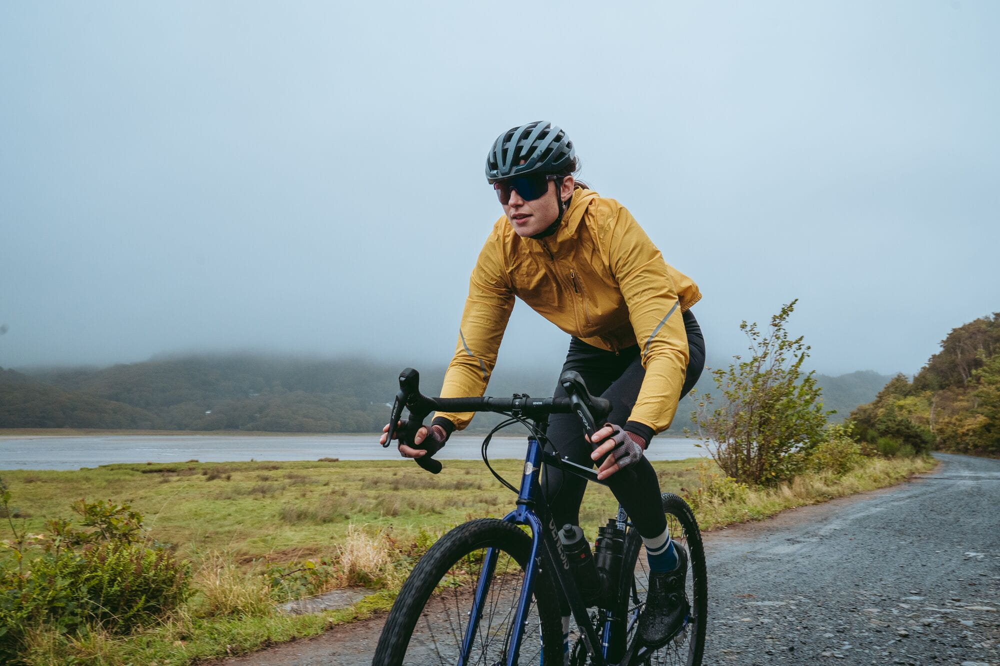 Madison Roam women's lightweight windproof packable jacket displayed folded and partially unfolded on a plain background.