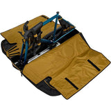 Thule RoundTrip MTB bike case with integrated work stand, designed for mountain and road bikes, showing sturdy exterior and stand setup.