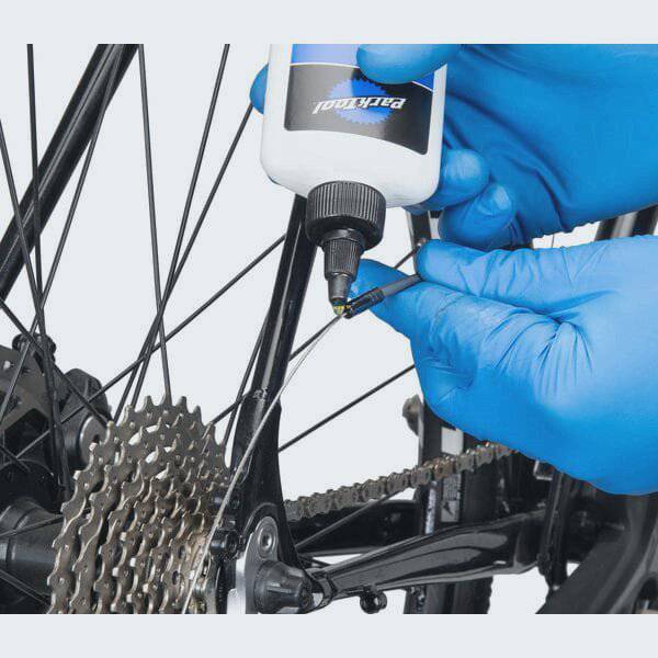 Park Tool CL-1.2 synthetic blend chain lube bottle for eco-friendly bike lubrication, suitable for workshop use.