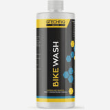 Gtechniq Bike Wash 250ml bottle of pH-neutral biodegradable cleaner for bikes, shown in workshop setting.