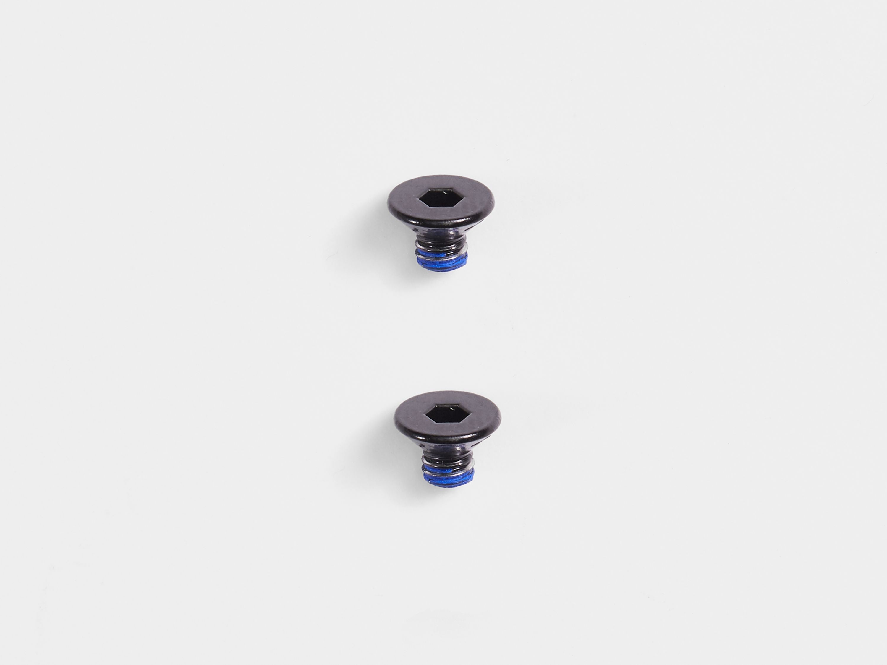 Pair of black Bontrager Pro Blendr Adapter Puck bolts M3 x 4mm for computer mount accessories, shown in close-up image.