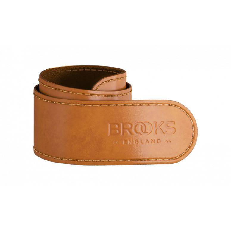 Brooks leather trouser strap in honey color, designed as cycling accessory for chain grease protection and style.