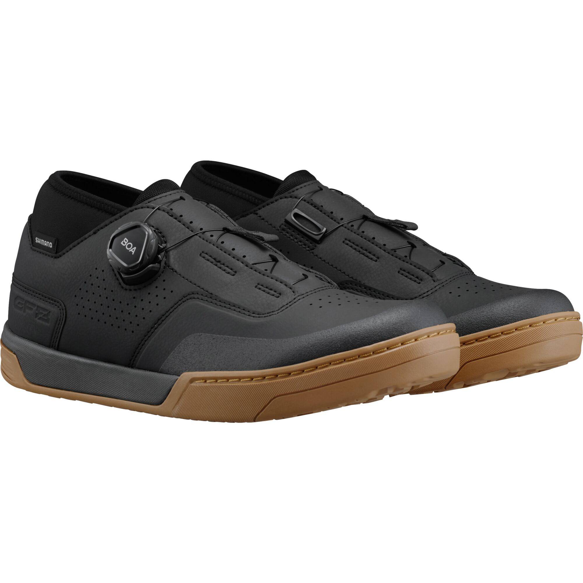 Shimano GF8 gravel riding shoes with BOA fit system and SPD compatibility, showing black shoes with secure lacing and rugged sole.