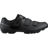 Shimano XC1 mountain bike shoes with SPD cleats, black and gray, featuring grip and comfort for cycling.