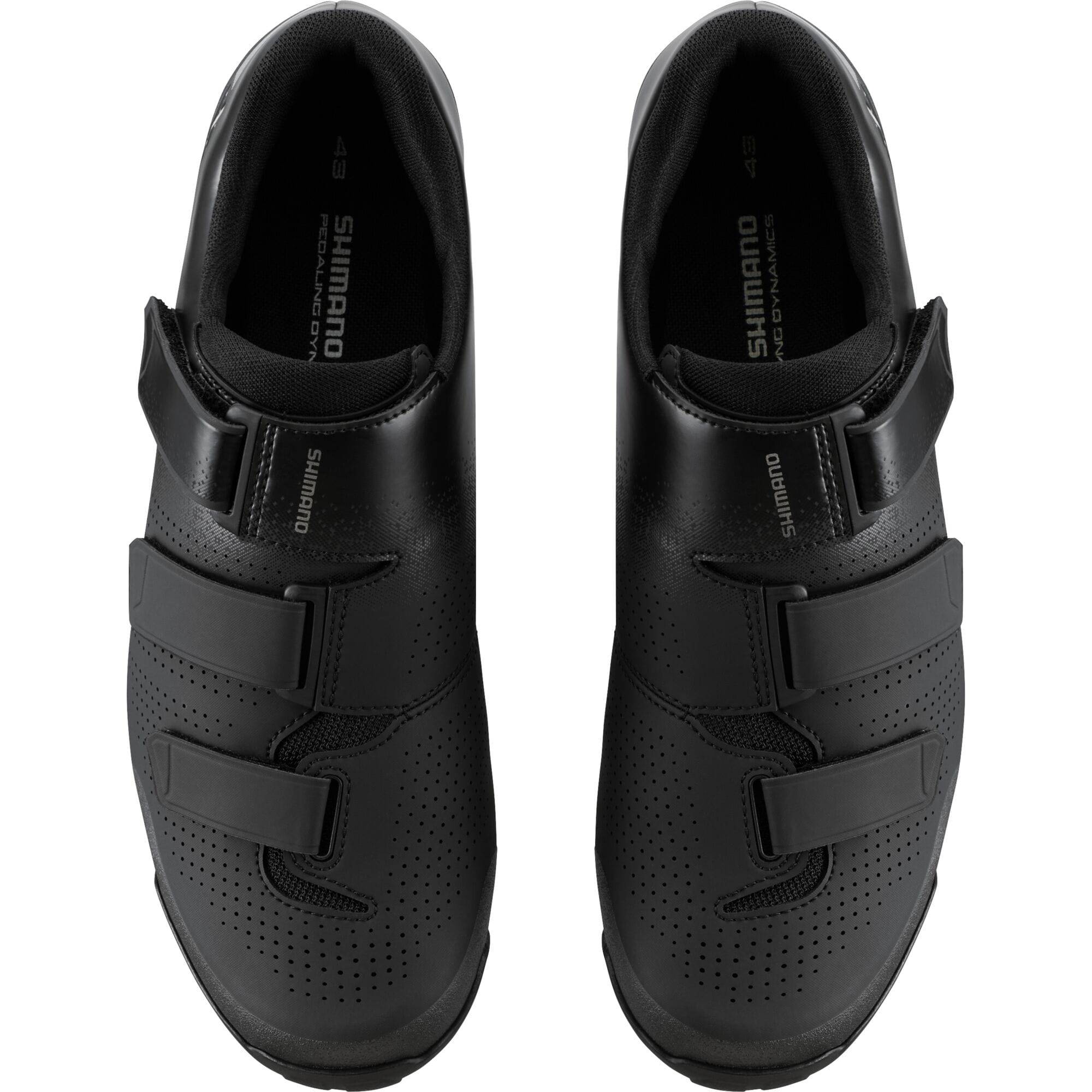 Shimano XC1 mountain bike shoes with SPD cleats, black and gray design, featuring grip and comfort for cycling enthusiasts.