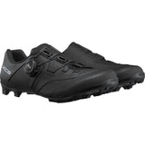 Shimano XC5 mountain bike shoes with BOA Fit System and carbon fiber midsole, black and gray, shown from the front angle.