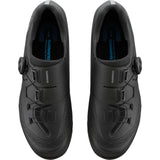 Shimano XC5 mountain bike shoes with BOA Fit System and carbon fiber midsole, black and gray, showing the sole and closure details.