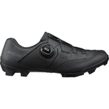 Shimano XC5W Women's MTB cycling shoes with BOA Fit System, black and white off-road biking footwear, showing sole and closure.