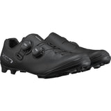 Shimano XC7 mountain bike shoes with BOA Fit System and SPD compatibility, showcasing a black and white design with secure closure.