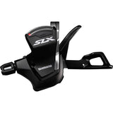 Shimano SLX SL-M7000 11-speed MTB Rapidfire shift levers mounted on handlebar for precise gear shifting.