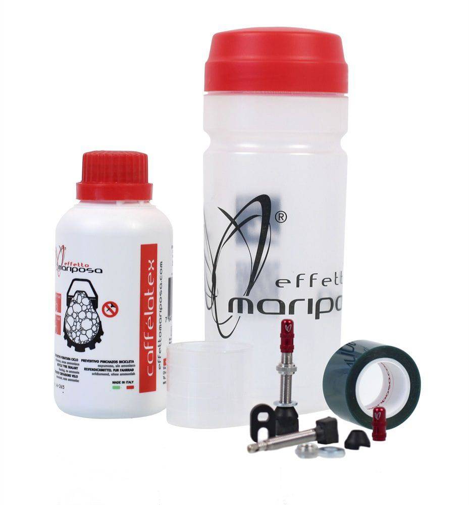 Effetto Mariposa Caffelatex tubeless sealant and repair kit for MTB and road bike wheels, shown in a workshop setting.