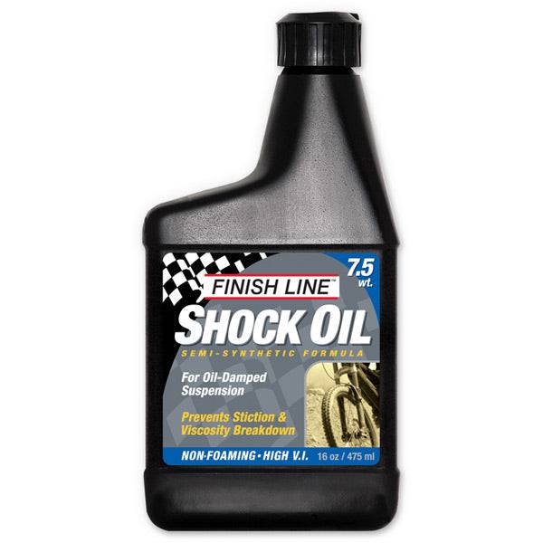 Finish Line Shock Oil 7.5 wt for bicycle suspension forks, 16 oz bottle, workshop use, clear liquid in a labeled container.