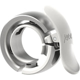 Knog Oi Prima bike bell with Wave-Tek technology, cable management features, and sleek design for cycling accessories.