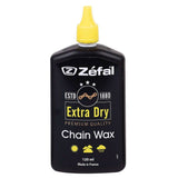 Zefal Extra Dry Chain Wax lubricant for bike drivetrain, showing application on bike chain for smooth gear shifts and protection.