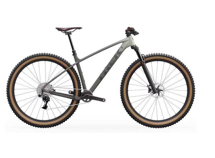 Trek Marlin 6 Gen 3 mountain bike with front suspension, knobby tires, and lightweight frame for trail and urban cycling.