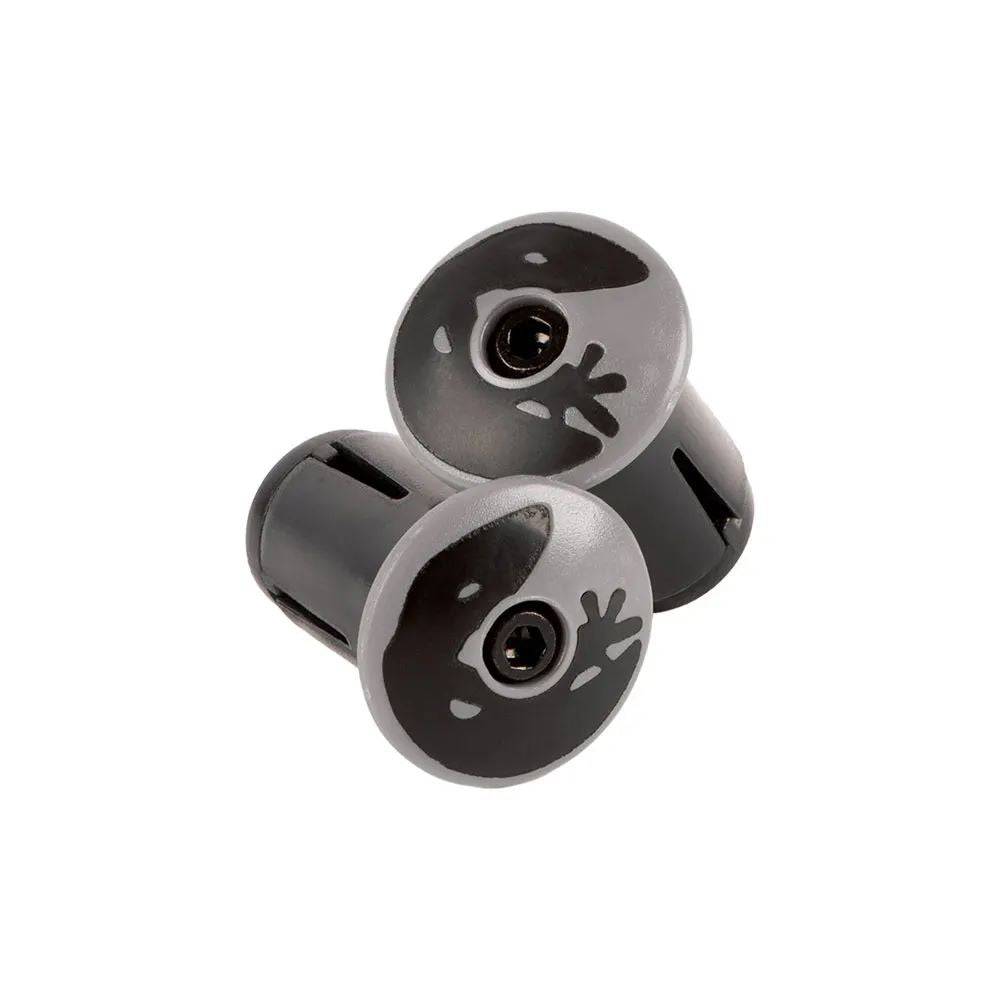 Lizard Skins DSP bar tape with packaged plugs for enhanced bike grip, showing textured black grip surface and installation accessories.