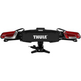 Thule OutPace 9012200 2-bike towball carrier with 13-pin connector mounted on a vehicle hitch, showcasing its sturdy design and attachment.