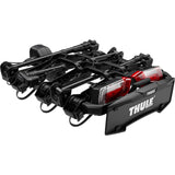 Thule OutPace 9013200 3-bike towball carrier with foldable design and 13-pin connector, mounted on a vehicle.