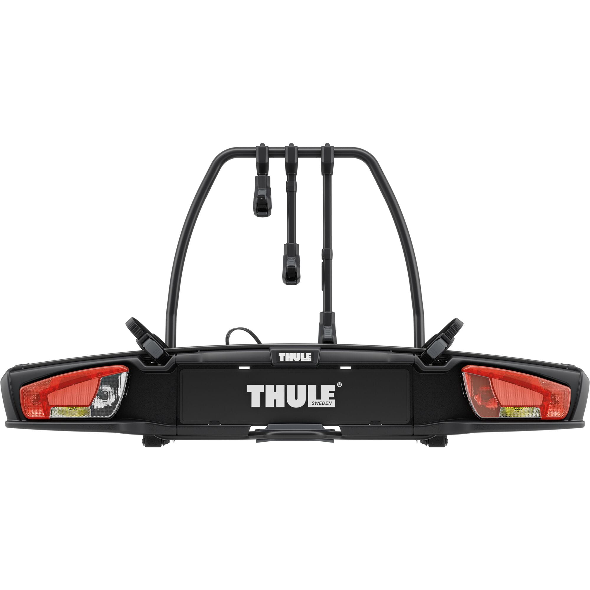 Thule VeloSpace 3-bike towball carrier with 13-pin connector for e-bikes and mountain bikes, mounted on a vehicle.