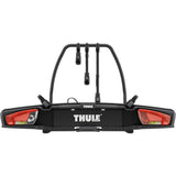 Thule VeloSpace 3-bike towball carrier with 13-pin connector for e-bikes and mountain bikes, mounted on a vehicle.