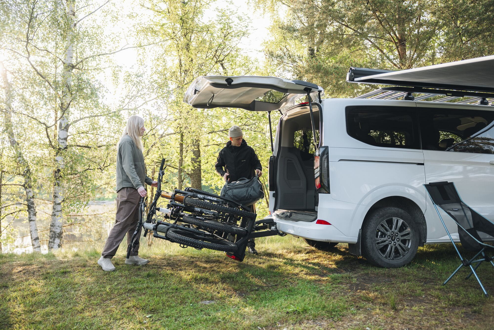 Thule VeloSpace 3-bike towball carrier with 13-pin connector for e-bikes and mountain bikes, shown installed on a vehicle.
