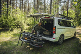 Thule VeloSpace 3-bike towball carrier with 13-pin connector, designed for e-bikes and mountain bikes, mounted on a vehicle.