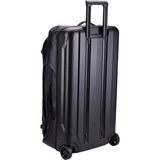 Thule Chasm rolling duffel bag in black, weather-resistant travel gear with durable construction and side handles.