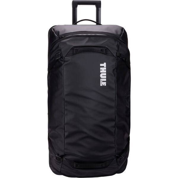 Black Thule Chasm rolling duffel bag showing durable weather-resistant fabric and sturdy wheels for travel accessories.