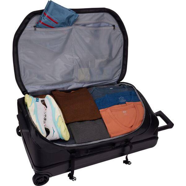 Black Thule Chasm rolling duffel bag showing weather-resistant fabric and sturdy wheels, ideal for durable travel accessories.