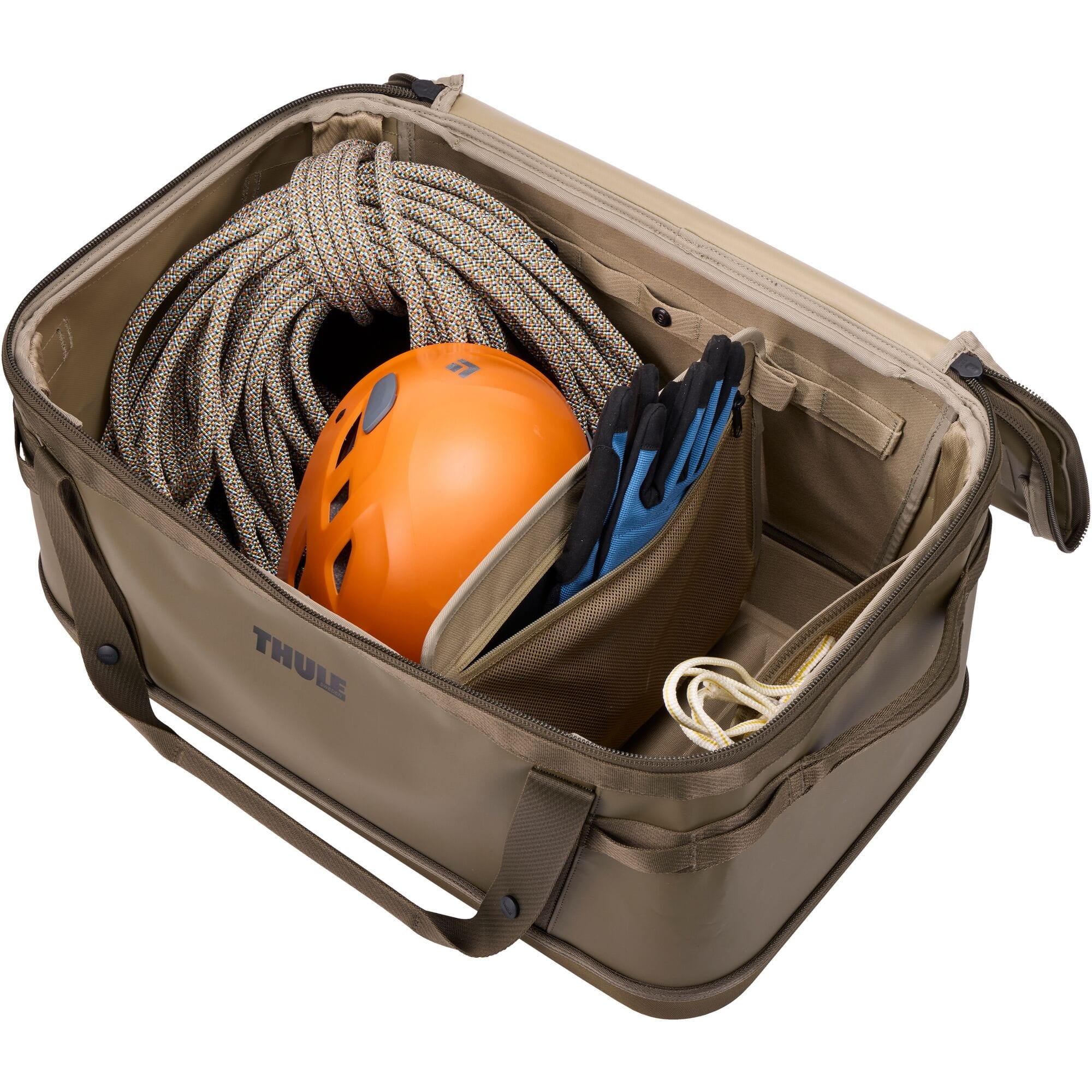 Thule Chasm Gear Hauler waterproof semi-rigid storage bag for travel and camping accessories, shown in outdoor setting.